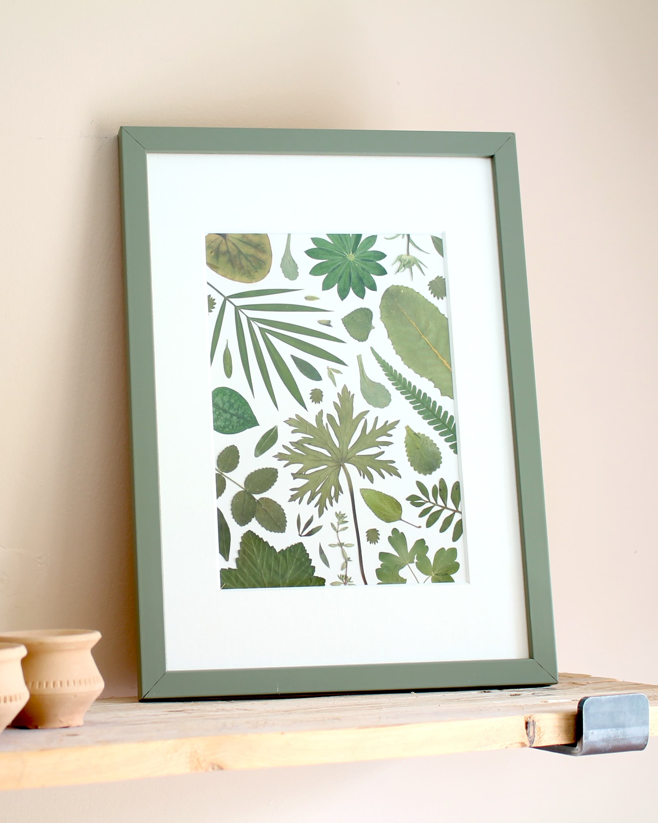 Pressed botanical fragments arranged in a mosaic-style composition